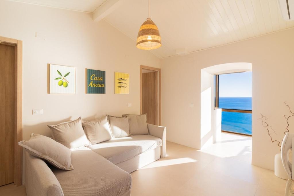 a living room with a white couch and a view of the ocean at Casa Anciua in San Bernardino