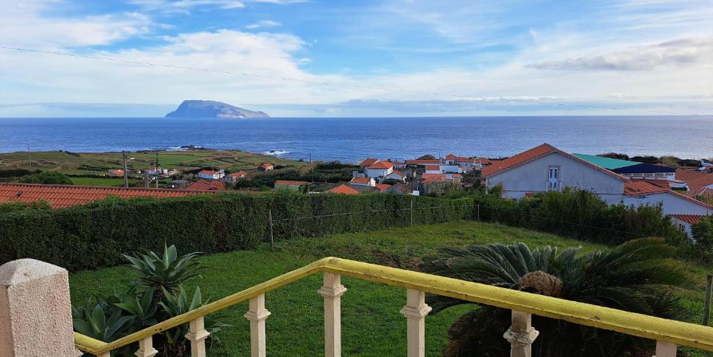 a view of the ocean from a balcony of a house at Casa da Maíssa in Ponta Delgada