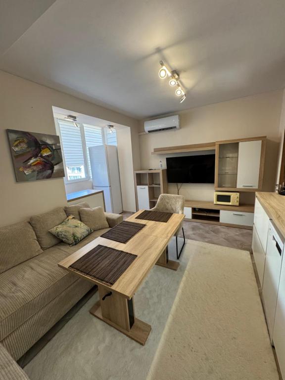 a living room with a table and a couch at Forum Apartment in Stara Zagora