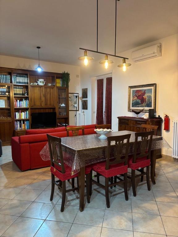 a living room with a table and chairs and a couch at Mary's House in Ciampino
