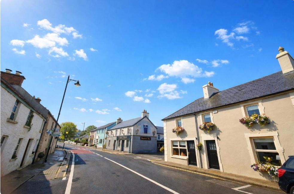 an empty street in a small town with buildings at The Corner house, Dromod in Leitrim