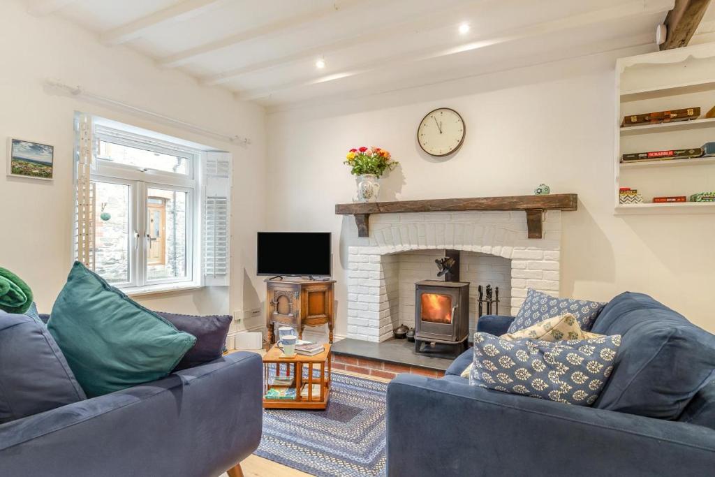 a living room with two blue couches and a fireplace at 2 Bed in Lynton oc-s33456 in Lynmouth
