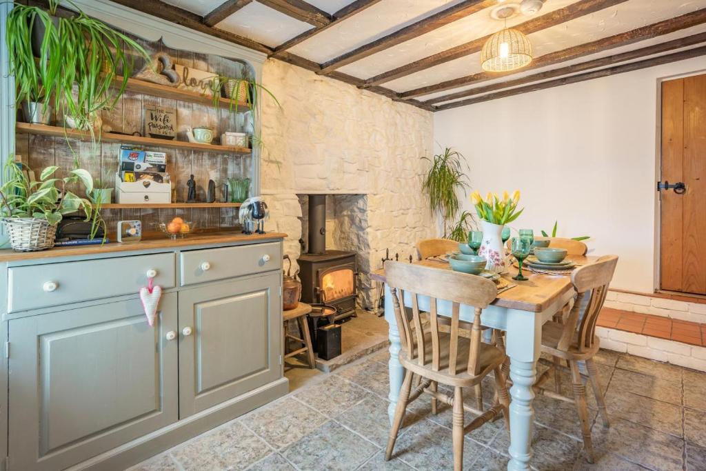 a kitchen with a table and a fireplace at 2 Bed in Trefil oc-n34478 in Nant-y-bwch
