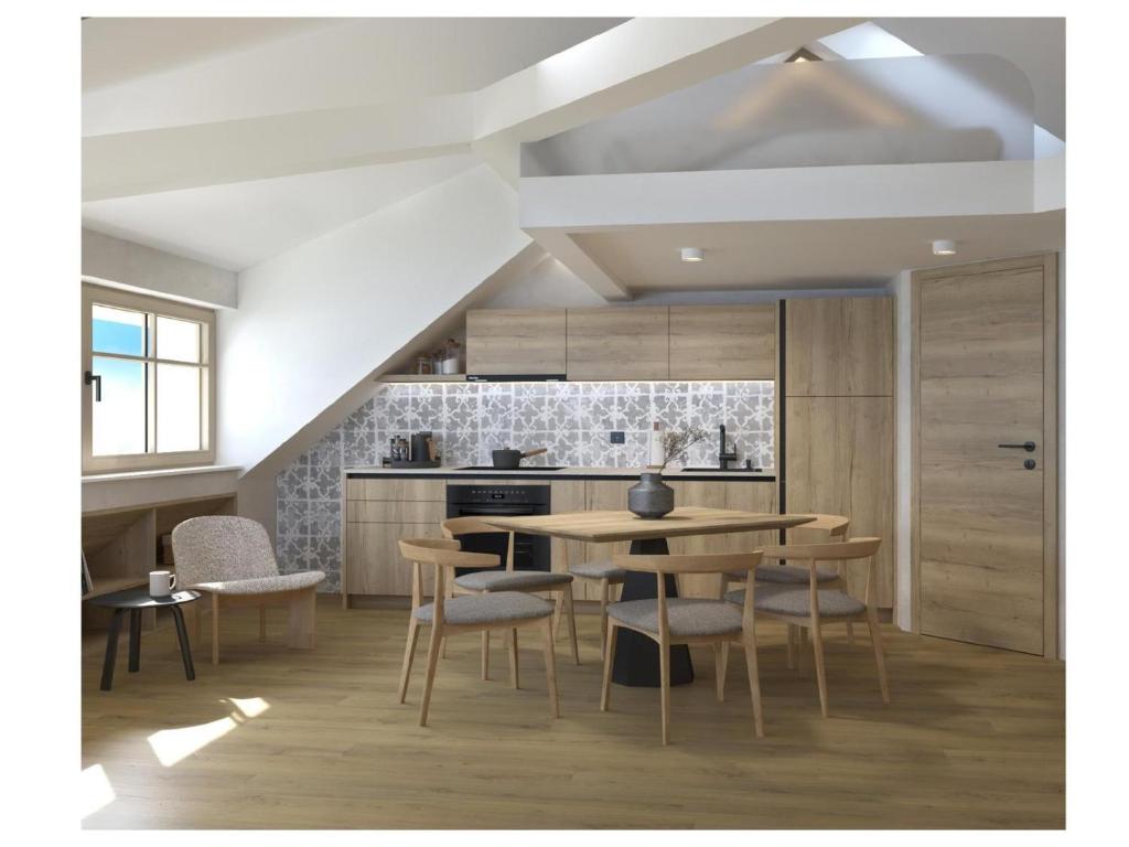 a kitchen with a wooden table and chairs at Golf Apartments in Kranjska Gora