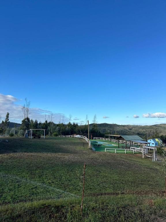 a field with a bunch of soccer at CIRyT La Montaña - Eco Cabañas y Turismo Rural in Tomé