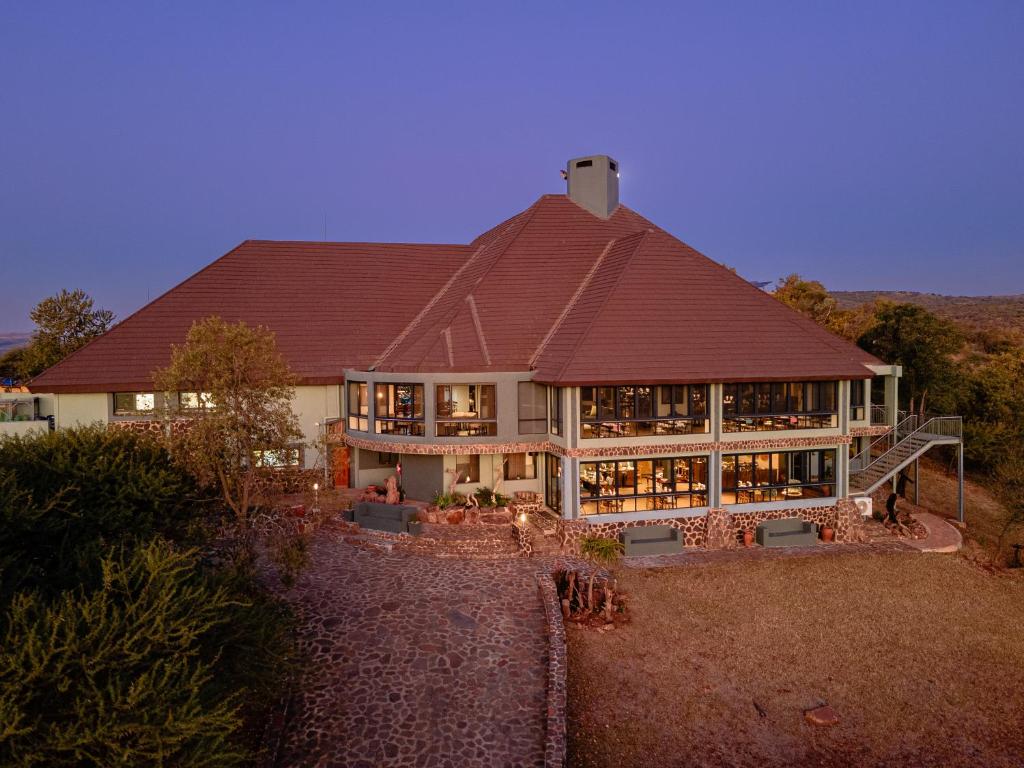 a large house with a red roof at Hannah Game Lodge in Ohrigstad