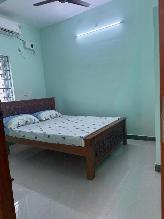 a bedroom with a bed in a room at JMS Garden Villa in Kanchipuram