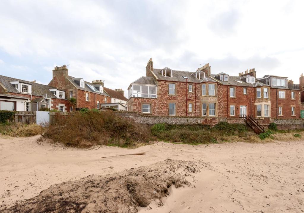 a building on the beach next to a sandy beach at Sandy Neuk in North Berwick
