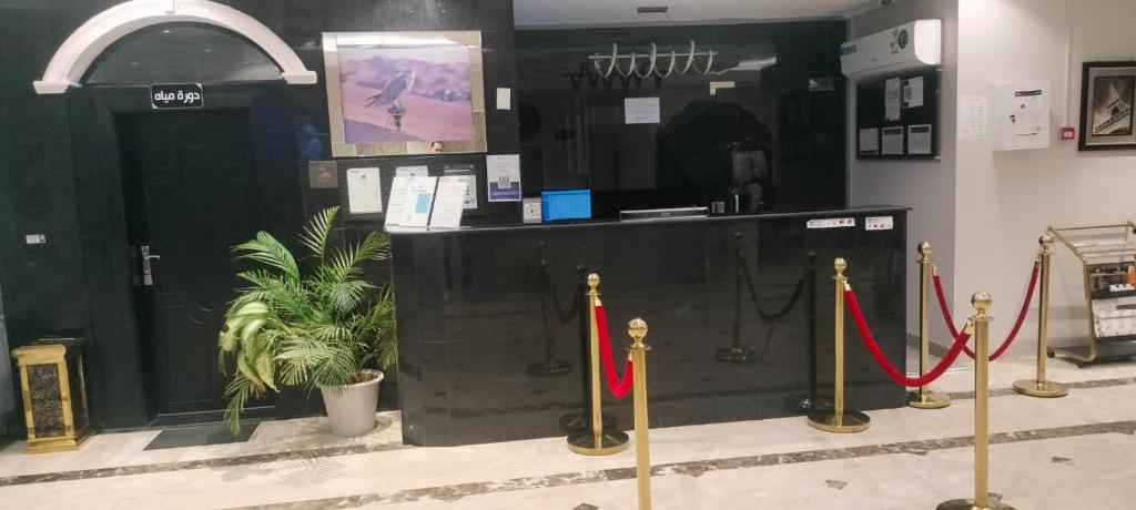 a store with red ribbon barriers and a counter at Saad in Cairo