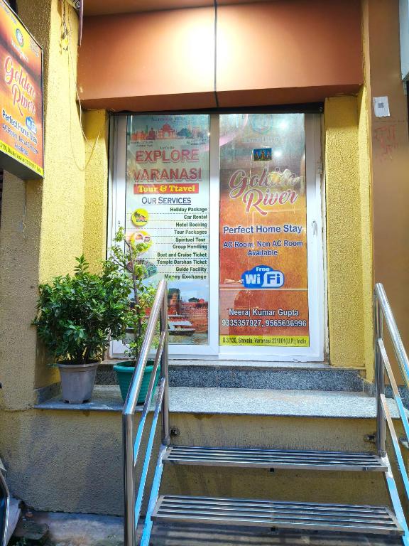 a door to a restaurant with a sign on it at Golden River Homestay in Varanasi
