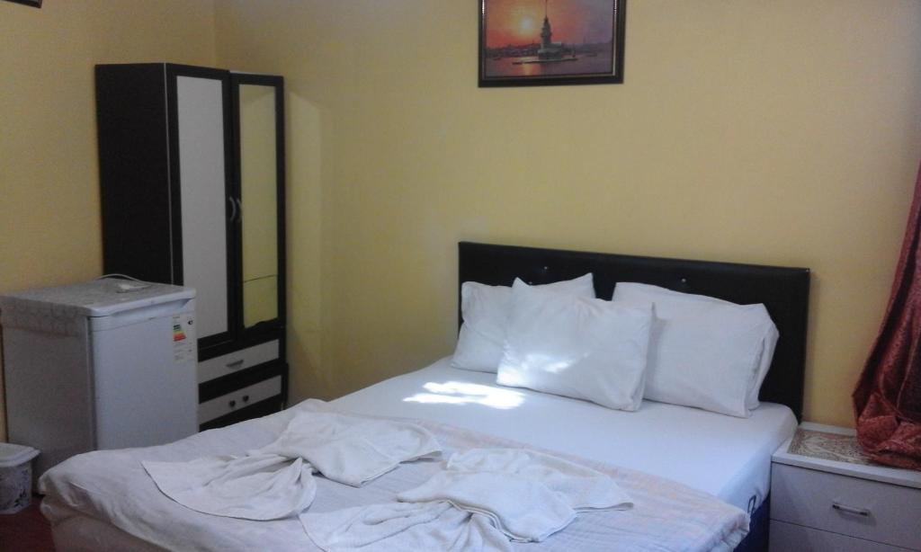 Postel nebo postele na pokoji v ubytování Bereket traveler Hotel