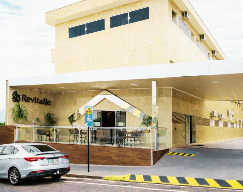 a car parked in front of a building at Revitalle Hotel in Votuporanga