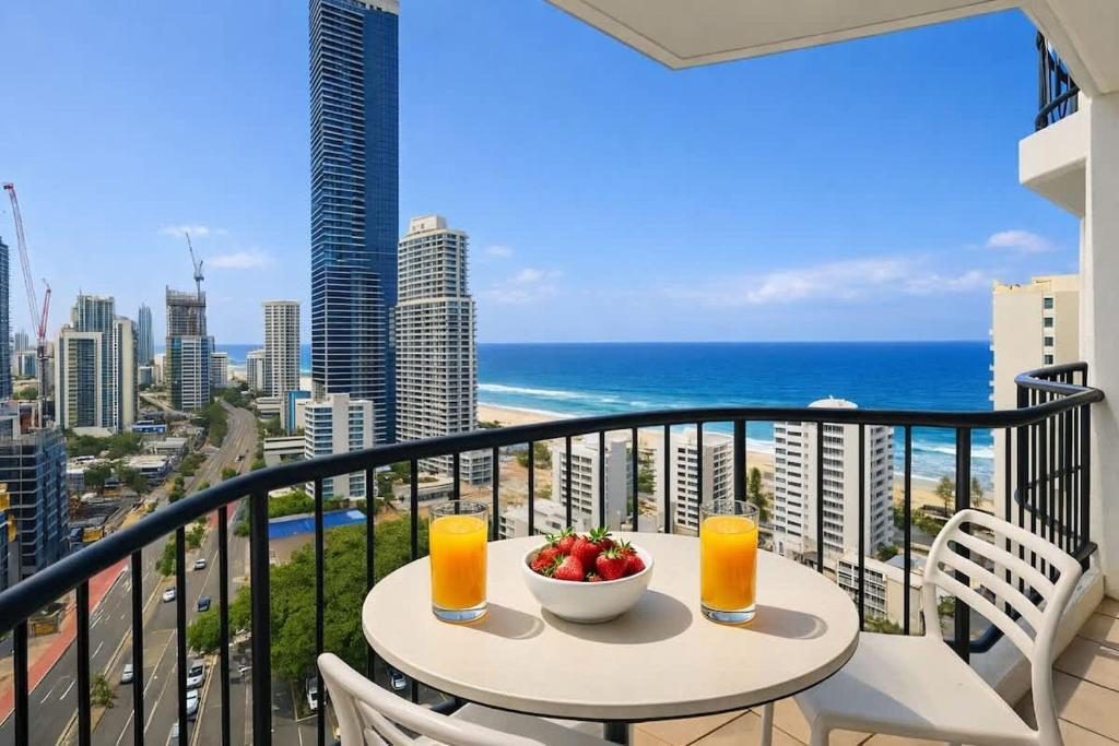 a table with a bowl of fruit on a balcony with the ocean at L19 Ocean View Suite - King Bed Wi-Fi in Gold Coast