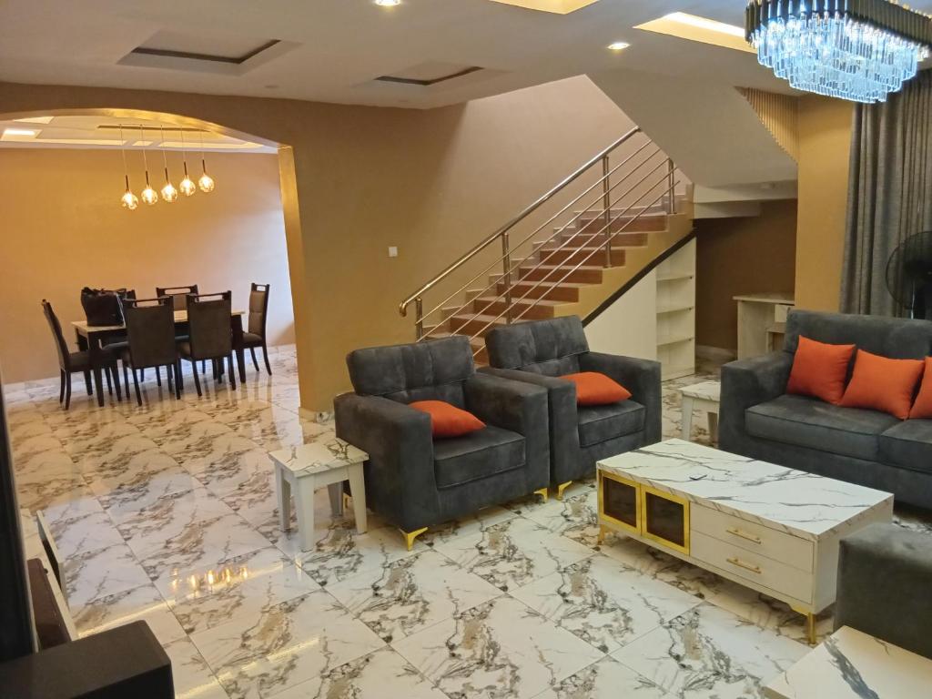 a living room with two couches and a table at Dipo Apartments in Badore