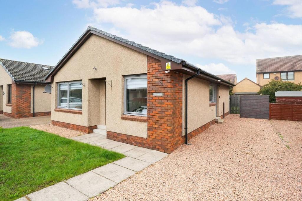 a home with a brick house with a driveway at Ellaburn in Barry