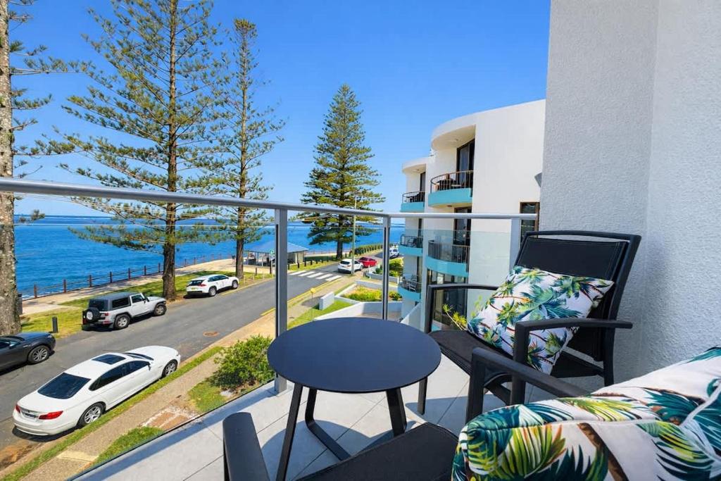 a balcony with a table and a view of the ocean at Golden Beach Oceanfront 3BR in Golden Beach