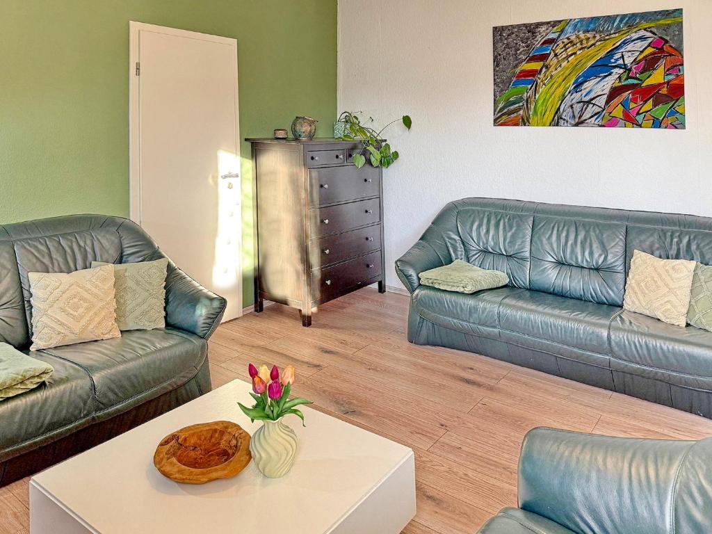 a living room with two couches and a coffee table at GurkenLoft in Lübbenau