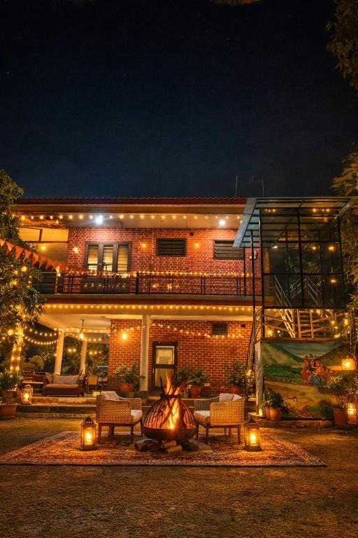 a building with a fire pit in front of it at night at Vida Homestay in Nakraunda