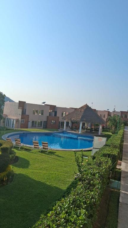 a swimming pool in the middle of a yard at Hermosa casa familiar con terraza comoda in Xochitepec