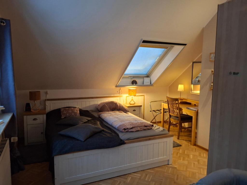 a bedroom with a bed with a skylight at Privatvermietung Giese in Kiel