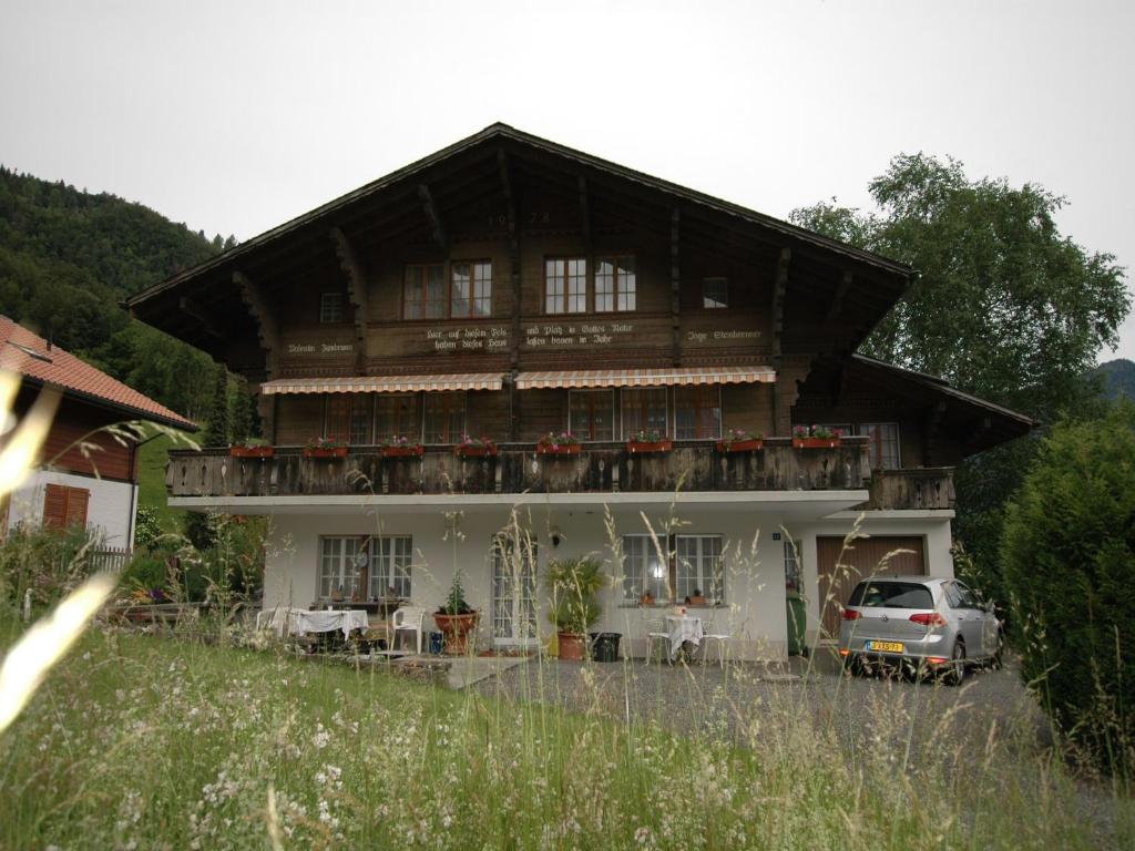 a house with a car parked in front of it at Chalet in Wilderswil with Jungfrau Views in Wilderswil