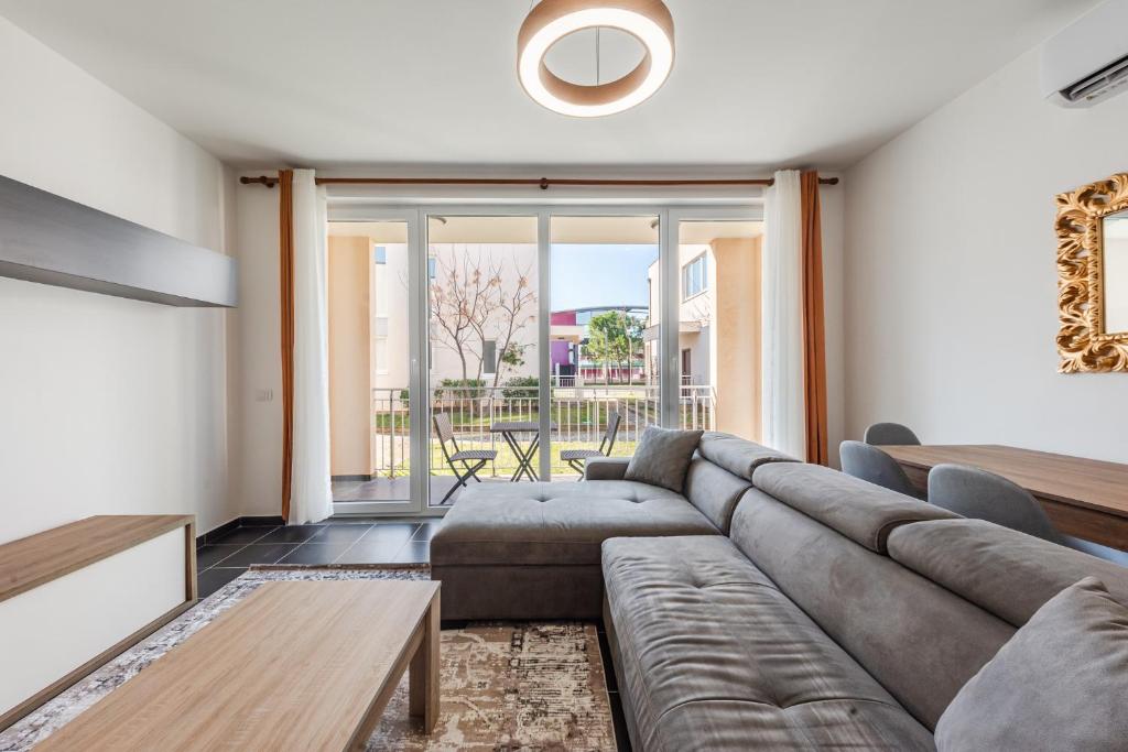 a living room with a couch and a table at Blue Haven Talea by PikHost in Tale