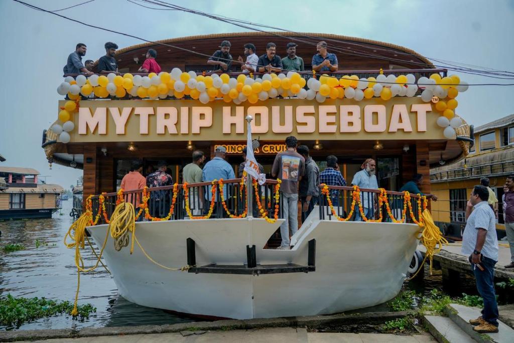 a group of people on a boat in the water at My Trip Houseboats in Alleppey
