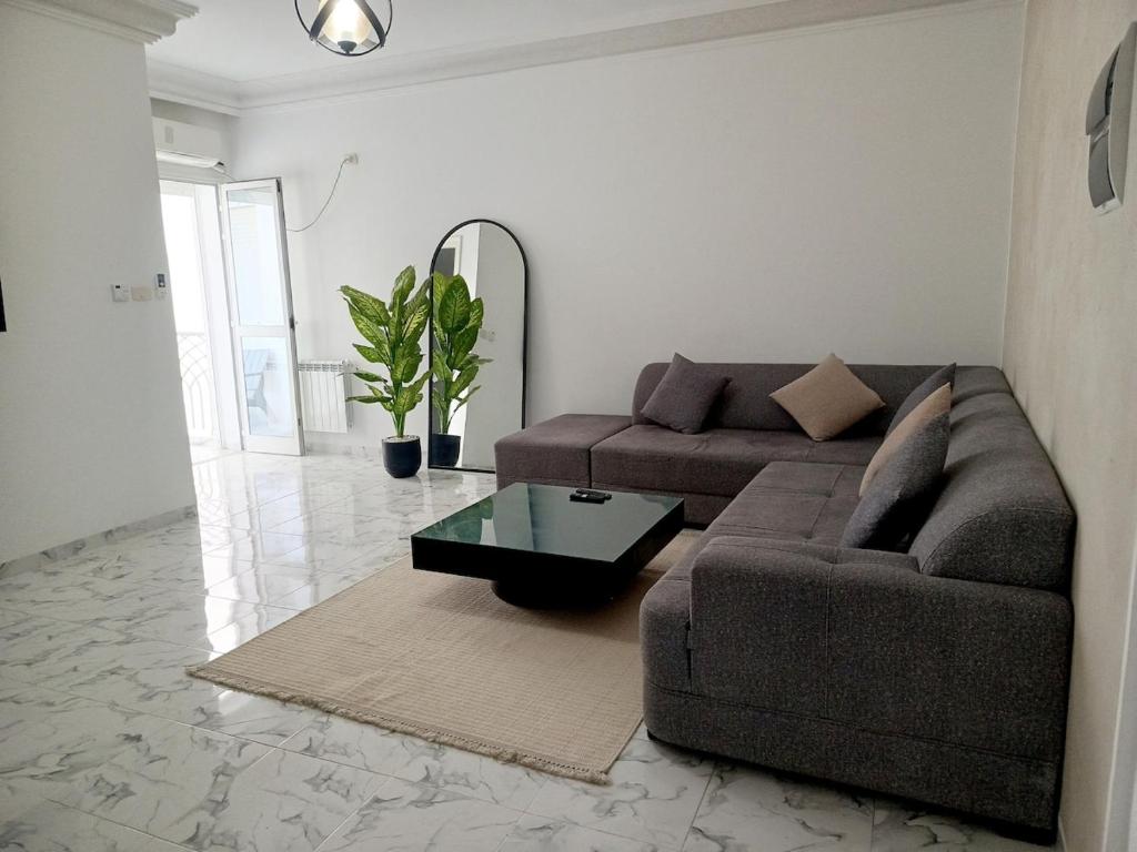 a living room with a couch and a table at modern apartment in Akouda