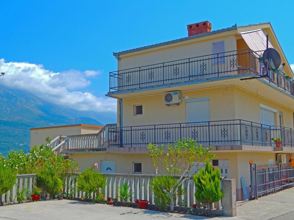 a yellow building with balconies on top of it at Apartment Anja in Tivat