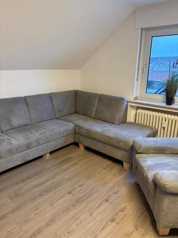 a living room with a couch and a window at Red Dot Apartment Bruno in Werne an der Lippe
