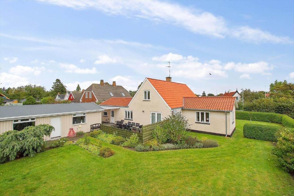 a house with an orange roof and a yard at 3720-Nexo-Nils-Plumsvej-5 in Neksø