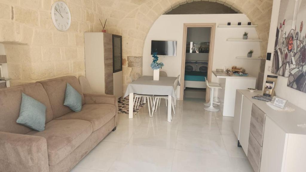 a living room with a couch and a table at Rossè B&B Holiday House in Trani