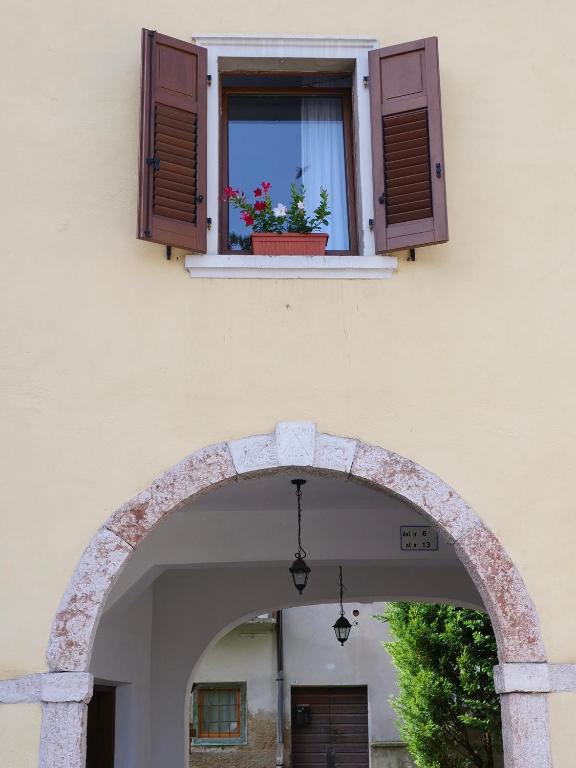 an archway with a window with a potted plant on it at Casa Nausicaa in Pergine Valsugana