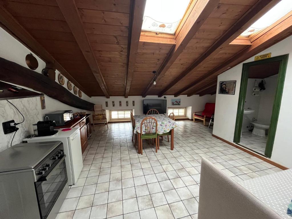 a kitchen with a table and a dining room at Ca’ Adele in Morbegno