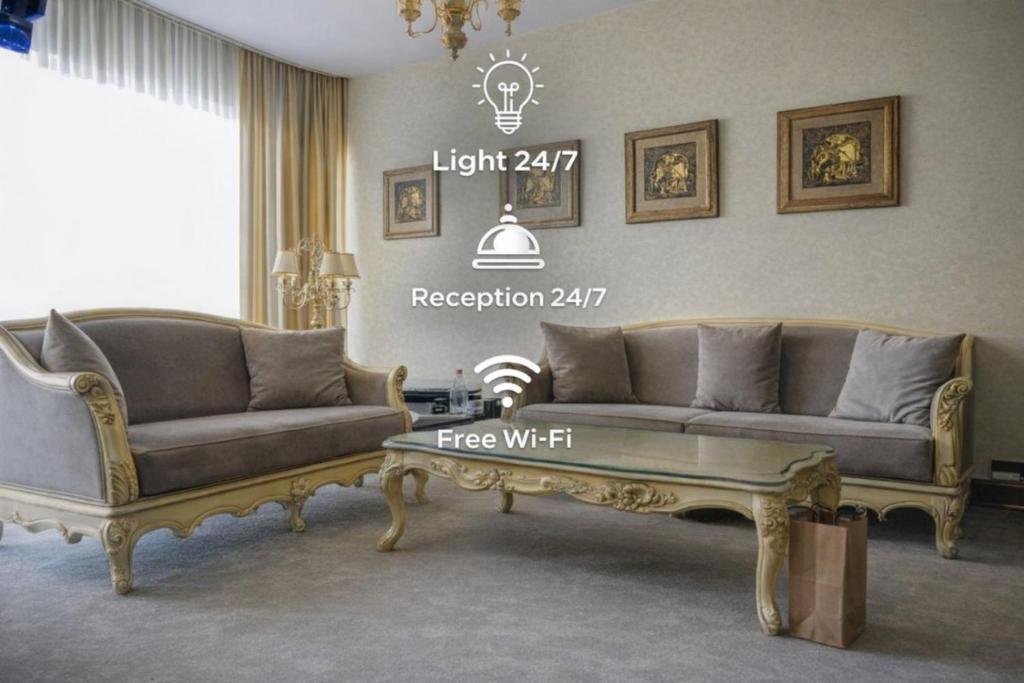 a living room with two couches and a coffee table at Hotel Feride in Vinnytsya