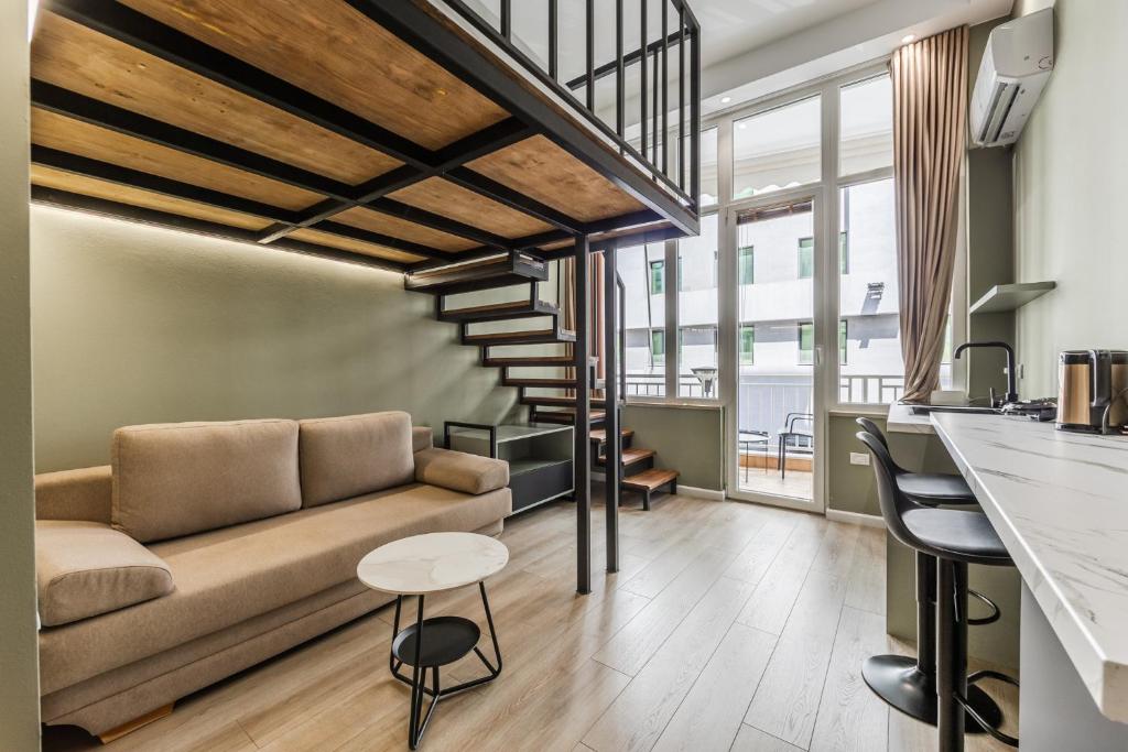 a living room with a couch and a table at Amel's Rooms by PikHost in Tirana