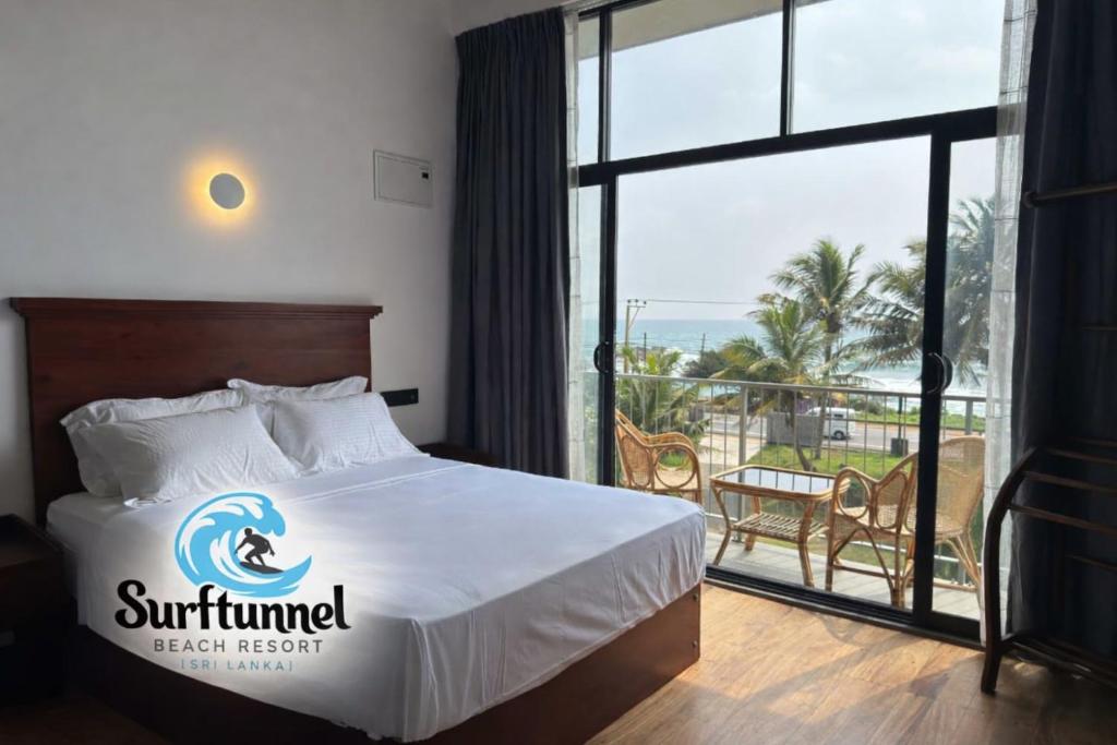 a hotel room with a bed with a sign on it at Surftunnel Beach Resort in Weligama