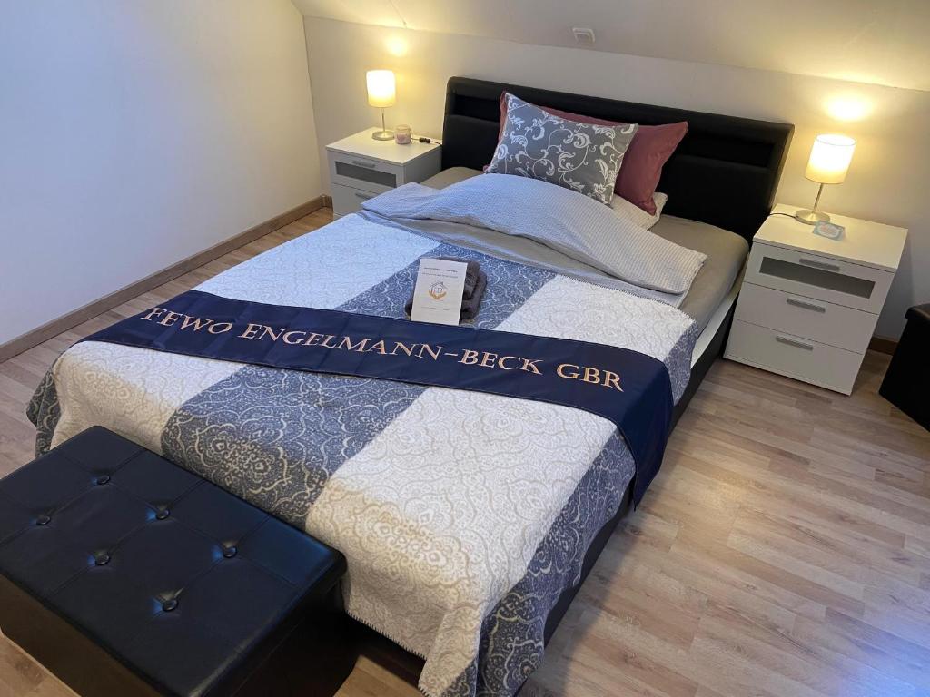a bedroom with a large bed and two night stands at Ferienzimmer 1 Engelmann-Beck in Hanstedt