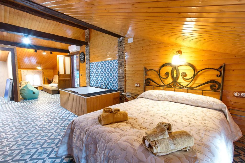 a bedroom with a bed with two teddy bears on it at Cuencaloft Casa Rural Eloy in Carboneras de Guadazaón