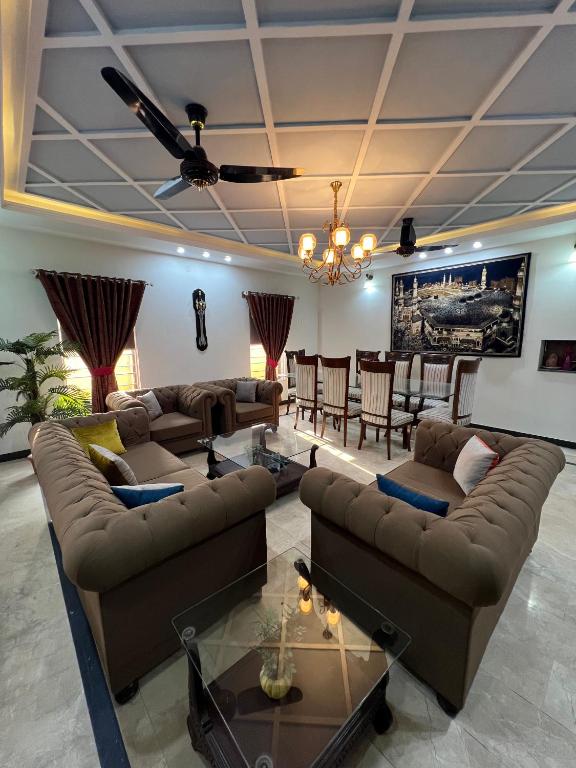 a living room with couches and a table at Urban Villa in Islamabad