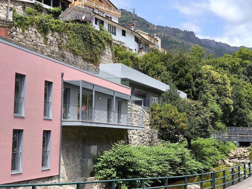 a pink building on the side of a mountain at Varandas do Gerês in Geres