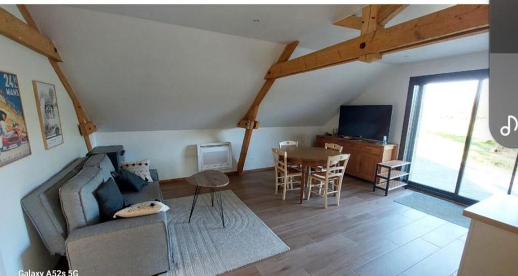 a living room with a couch and a table at Maison de 50m2 à la campagne in Pirmil