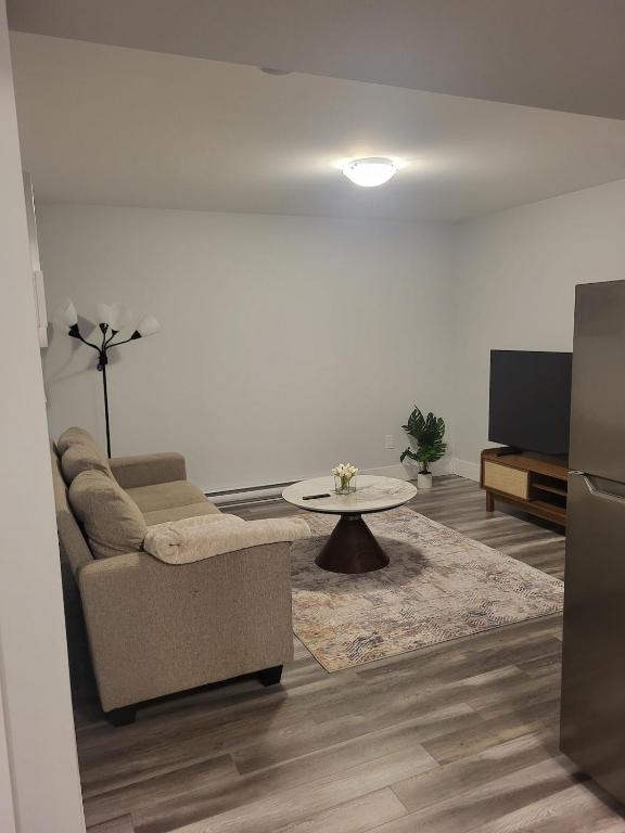 a living room with a couch and a table at Peace Home in Dieppe