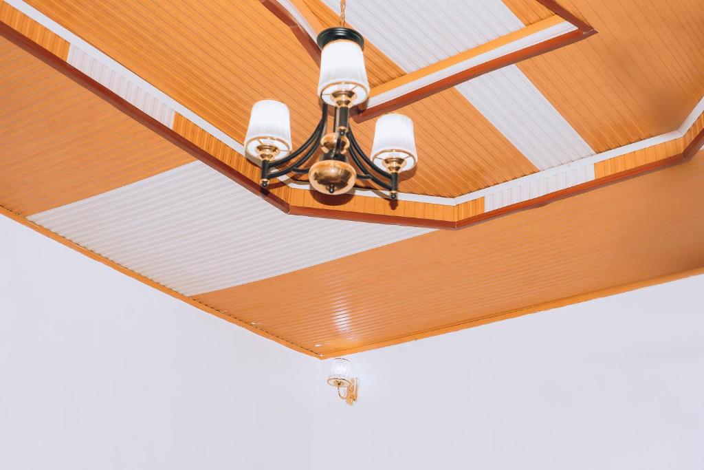 a chandelier hanging from a ceiling in a room at Davidson's guest house in Kayonza