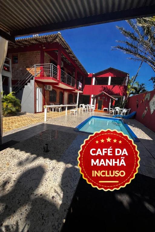 a sign that reads cafe da manuana incolis in front of a house at Pousada NativaMar in Guaratuba