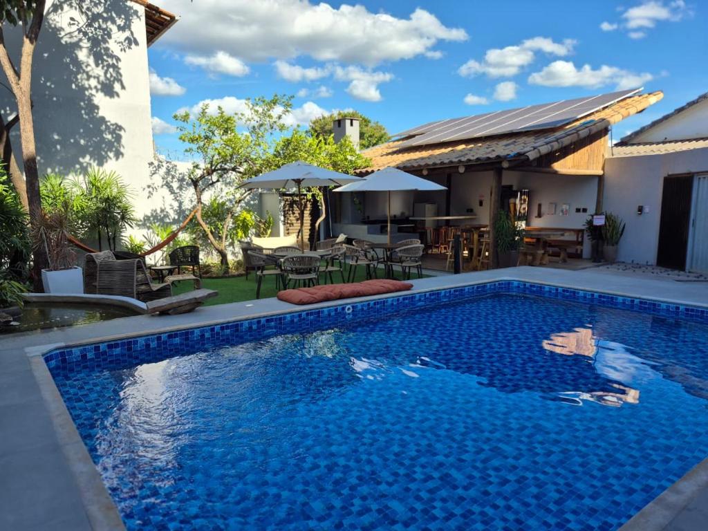 a swimming pool in front of a house at Real Hotel in Sete Lagoas