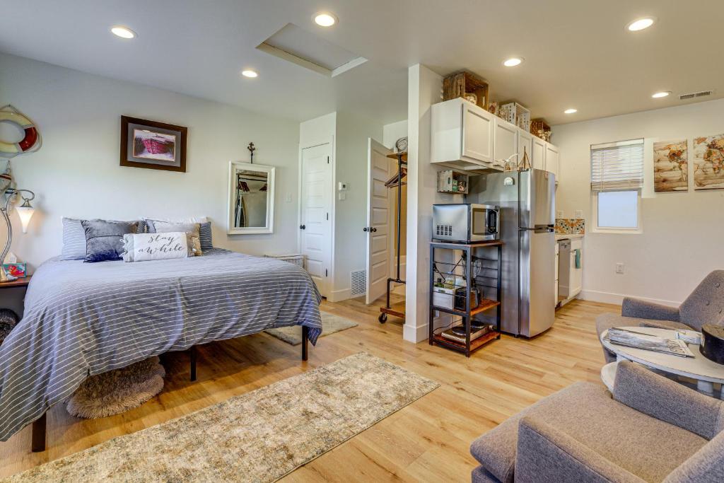a bedroom with a bed and a living room at Dtwn Walkability! Grand Junction Couple's Retreat in Grand Junction