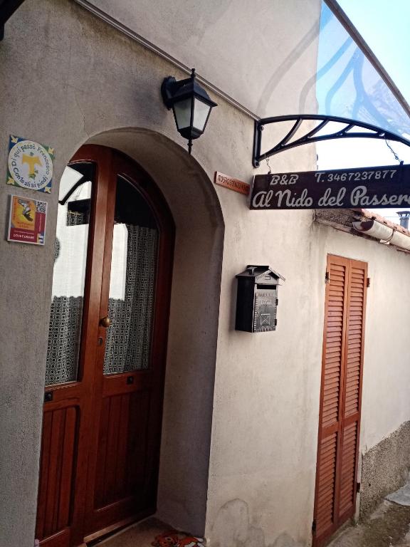 an entrance to a building with a wooden door at Al Nido Del Passero 1 in Greccio