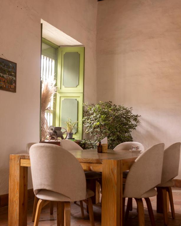 a dining room with a wooden table and chairs at La Liebre bed and breakfast in El Retiro