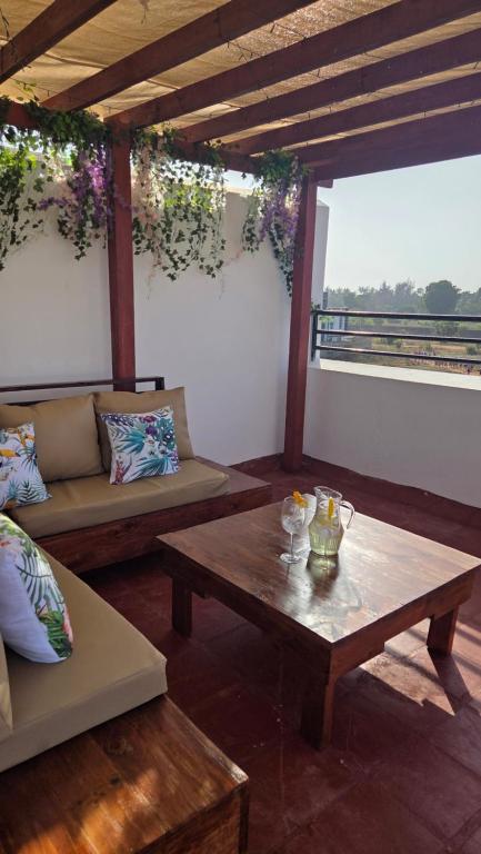 a living room with couches and a table in a room at Seasalt & Sand in Mtwapa